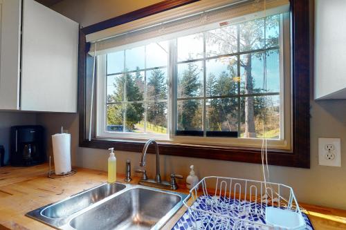 a kitchen with a sink and a window at Sweet Netarts in Tillamook