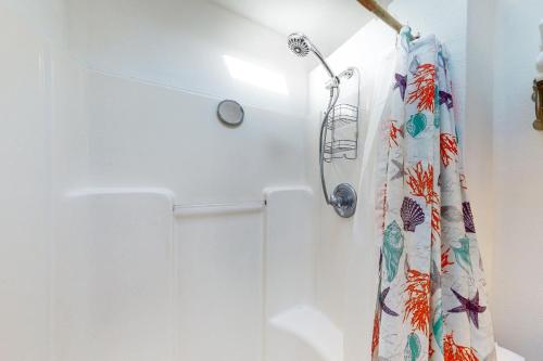 a shower curtain is hanging in a bathroom at Sweet Netarts in Tillamook