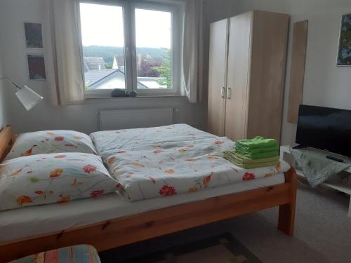 a bed in a room with a window at Haus Andreasse am Wiehengebirge in Minden