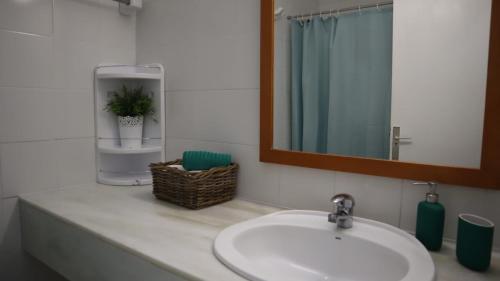 a bathroom counter with a sink and a mirror at Bungalow Einstein in Maspalomas