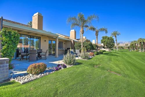 a house with a patio and a yard at Golf Resort Getaway with Pool Access in Palm Desert in Palm Desert
