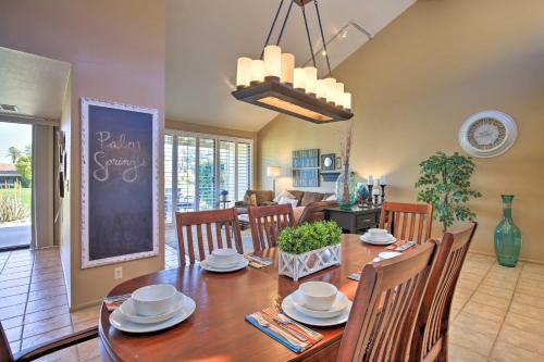 a dining room and living room with a table and chairs at Golf Resort Getaway with Pool Access in Palm Desert in Palm Desert