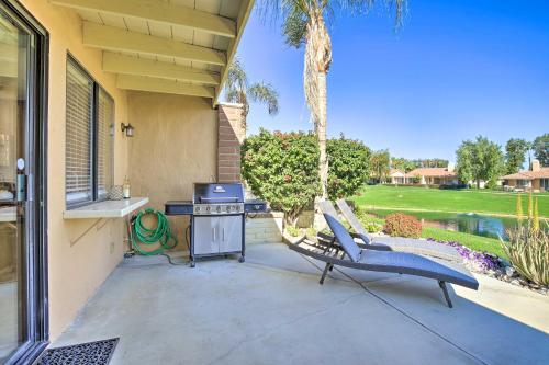 a patio with a grill and a chair next to a house at Golf Resort Getaway with Pool Access in Palm Desert in Palm Desert