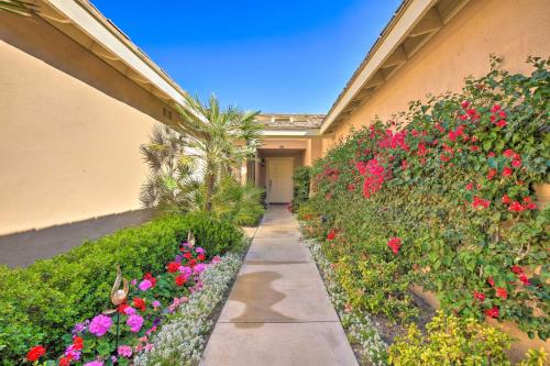 a walkway in front of a building with flowers at Golf Resort Getaway with Pool Access in Palm Desert in Palm Desert