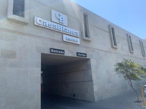 a building with a garage with a sign on it at Motel Casablanca in Guadalajara