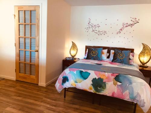 a bedroom with a bed with a colorful comforter at shangrila waterfront vacation home in Pender Island