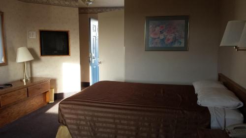 a hotel room with a bed and a television at Travelodge by Wyndham Page, View of Lake Powell in Page