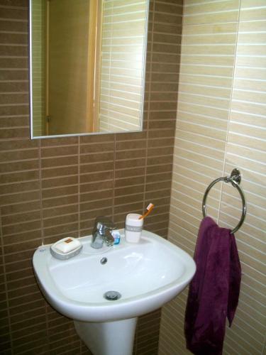 a bathroom with a white sink and a mirror at A209 Coralli Spa, Cyprus - Med View Studio in Protaras