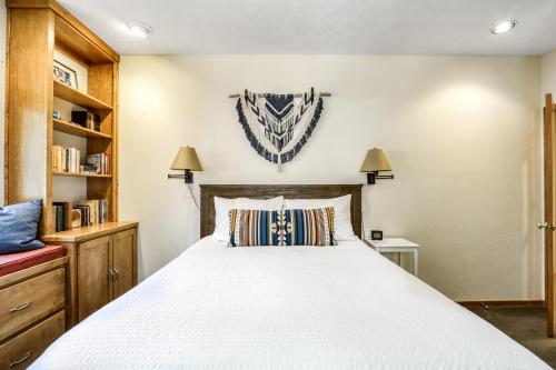 a bedroom with a large white bed and shelves at Rock Ridge 39 in Black Butte Ranch