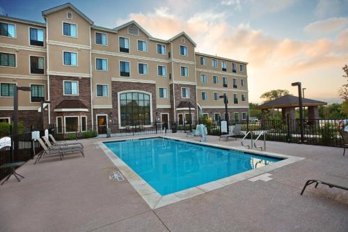 a swimming pool in front of a building at Staybridge Suites Austin South Interstate Hwy 35, an IHG Hotel in Austin