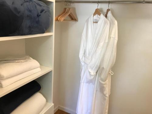 a white robe is hanging in a closet at Ascot Road - discover Bowral in Bowral