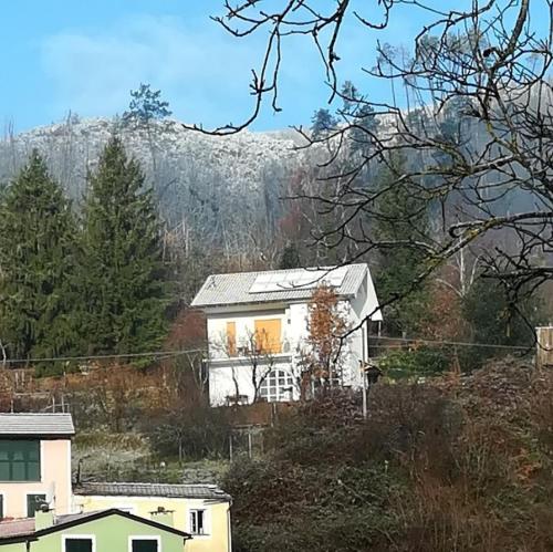 a house on a hill with a mountain in the background at Sea Levanto and Cinque Terre Calm, cool, freedom,for children and pet Parking in Carrodano Inferiore