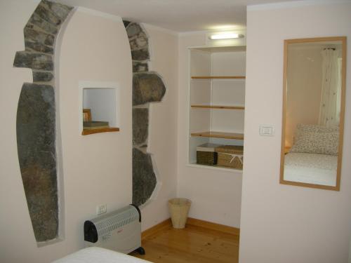 a room with a mirror and a room with a bed at Welcome to Casa Terracotta a cosy self-catering holiday home. in Masanti