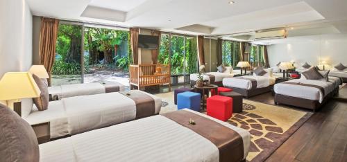 a hotel room with beds and a large window at Sangsuri Villa 2 in Choeng Mon Beach