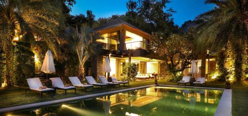 a villa with a swimming pool and a resort at Sangsuri Villa 2 in Choeng Mon Beach