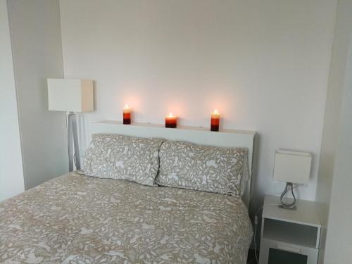 een slaapkamer met twee kaarsen op het bed bij Th e White House in Palamartsa in Palamarza