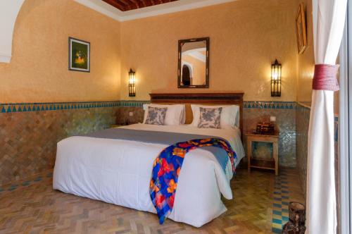 a bedroom with a large bed in a room at Charming villa in the heart of Marrakech palm grove in Marrakesh
