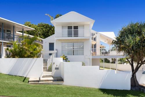 a white house with a white fence in front of it at The White House - Spectacular Ocean Views, WiFi, Central Coolum in Coolum Beach