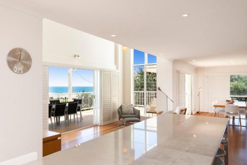 a living room with a view of the ocean at The White House - Spectacular Ocean Views, WiFi, Central Coolum in Coolum Beach