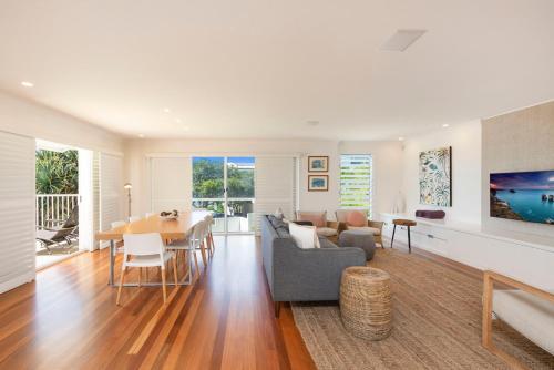 a living room with a table and a dining room at The White House - Spectacular Ocean Views, WiFi, Central Coolum in Coolum Beach