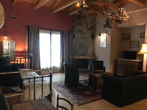 a living room with a large window and a fireplace at Montanema Handmade Village in Platanákos