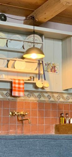 a kitchen with a light hanging over a kitchen counter at Montanema Handmade Village in Platanákos