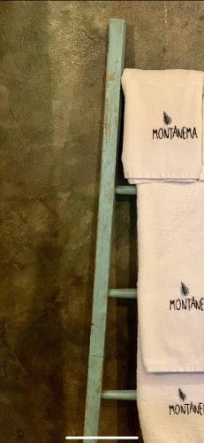 a ladder sitting against a wall next to two towels at Montanema Handmade Village in Platanákos