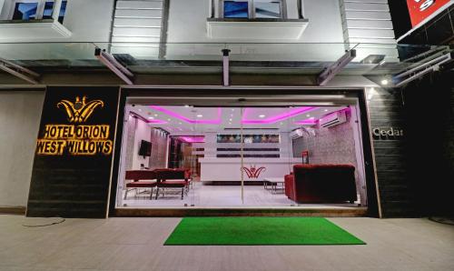 a store front with red chairs and pink lights at Treebo Orion Sapphire, Beck Bagan in Kolkata