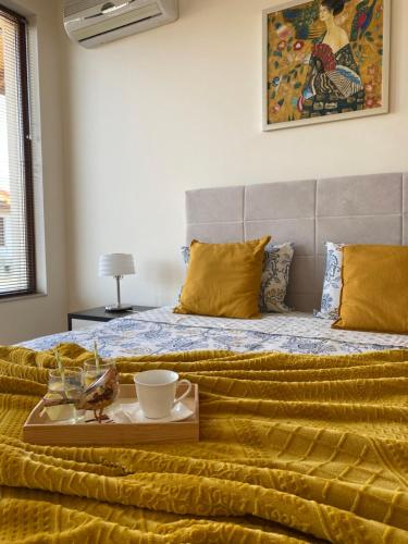 a bed with a tray of food on top of it at Sunrise Lighthouse Golf Private Villa in Balchik
