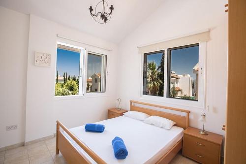 a white bedroom with a bed and two windows at Villa Protaras Eos Modern 3BDR Protaras Villa with Pool Short Walk to all beachresort centre in Protaras