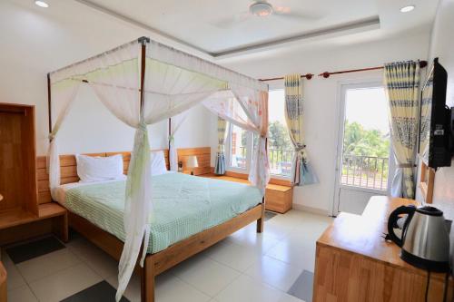 A bed or beds in a room at MAY Bungalow