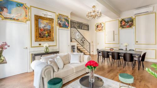 a living room with a white couch and a table at Royale 3 Bedroom, 2 Bathroom Apartment With AC - Louvre in Paris