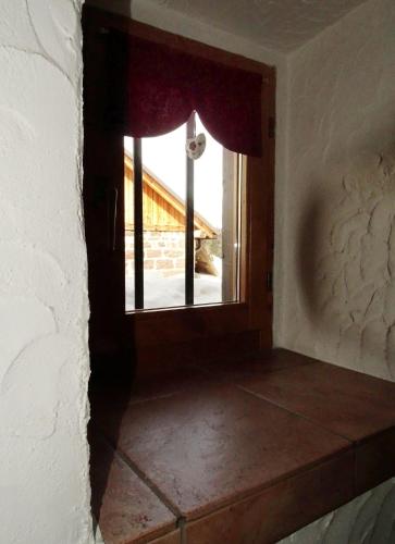 an empty room with a window in a house at Baita Casera Caviazza in Falcade