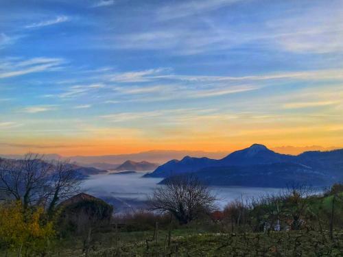 a view of a foggy valley with mountains in the background at Banjo Rustic House Lake view in Virpazar
