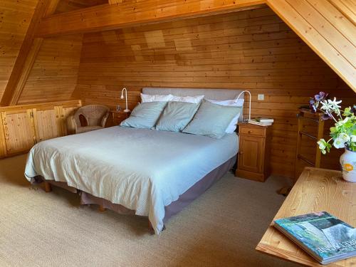 a bedroom with a bed and a wooden wall at Le Huic maison de marin lambrissée in Bénodet
