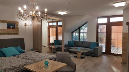 een woonkamer met een bank en een tafel bij Village Romantic Apartment by Český Krumlov - adults only in Střížov