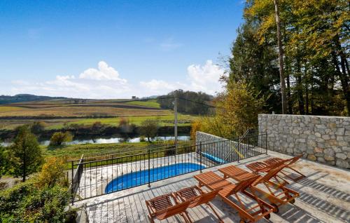 a group of chairs sitting next to a swimming pool at By Riverhill in Karlovac