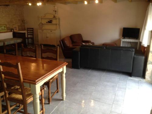 a living room with a couch and a table at Saggitarius, Les Constellations in Doeuil-sur-le-Mignon
