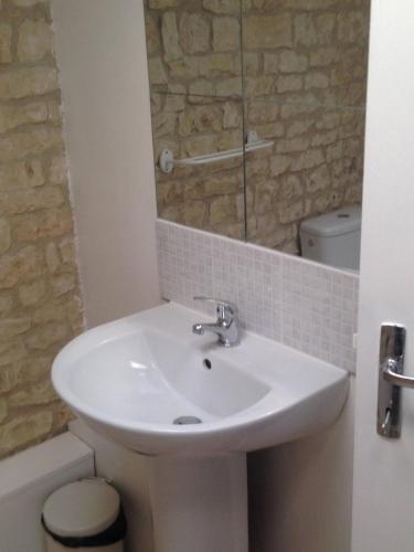 a bathroom with a sink and a toilet and a mirror at Saggitarius, Les Constellations in Doeuil-sur-le-Mignon