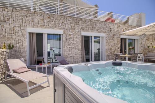a jacuzzi tub in a yard with a patio at Jacuzzi Holiday Homes by LoveSud in Leuca