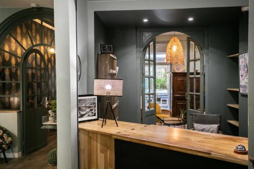 a bar with a wooden counter in a room at Boutique Hôtel Azur in Marseille