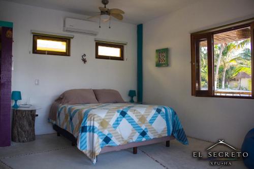 a bedroom with a bed and a window at Room in Lodge - Ocean View Cabin below in Xpu Ha