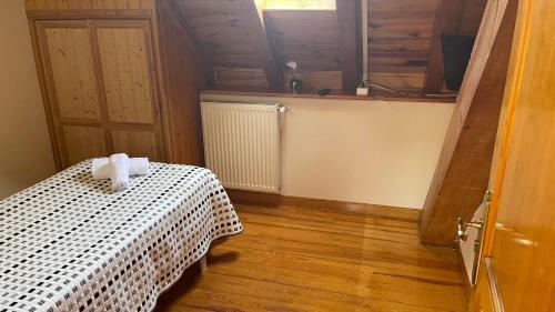 a bedroom with a bed and a dresser at Hostal Ezkaurre in Isaba