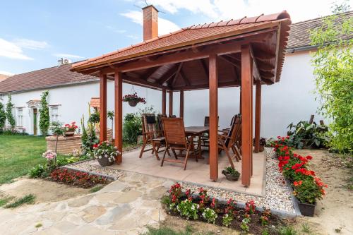 a wooden gazebo with a table and chairs at U Stařenky in Dolní Bojanovice