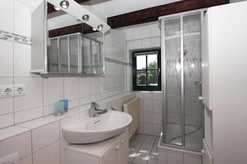 ヴィーク・アウフ・リューゲンにあるFerienhaus Storchennest Haus Terrasse, Gartenの洗面台とシャワー付きの白いバスルーム