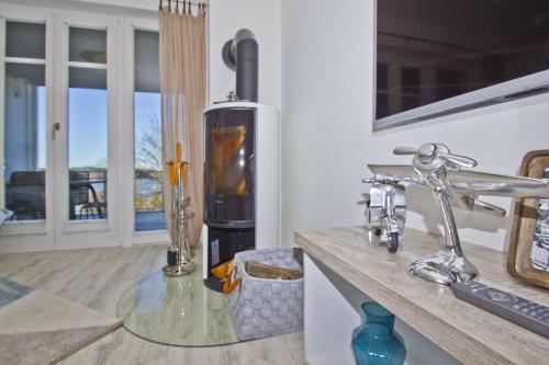 a kitchen with a wood stove on a counter at Ferienwohnung mit Balkon, Kamin und Sauna - Ferienresidenz Zwei Bodden FeWo 2-9 in Lietzow