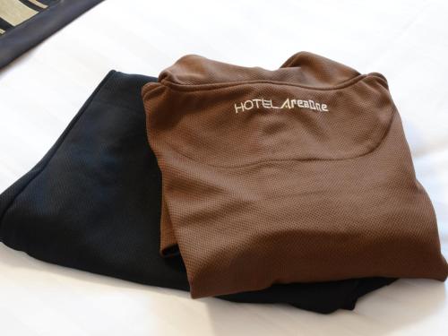 a brown and black bag sitting on a table at Hotel AreaOne Obihiro in Obihiro