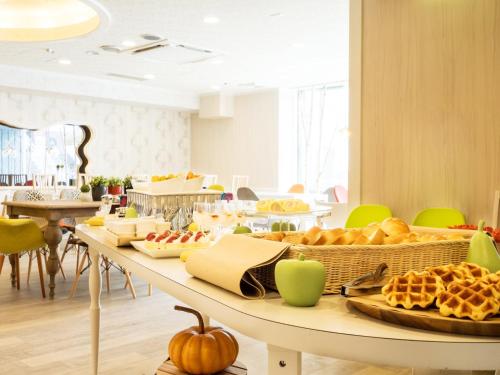 a table filled with lots of different types of food at Hotel AreaOne Obihiro in Obihiro