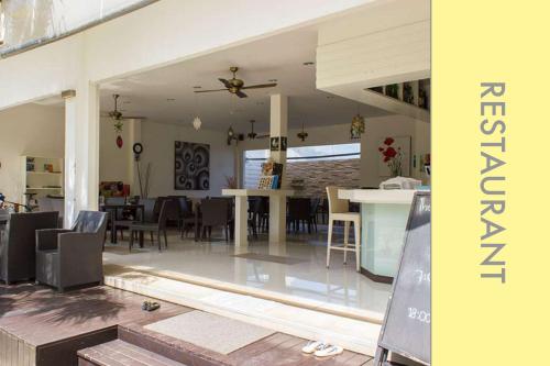 a living room and dining room with a ceiling fan at Pool Access 2 BDR Stylish Condo in Kamala Beach