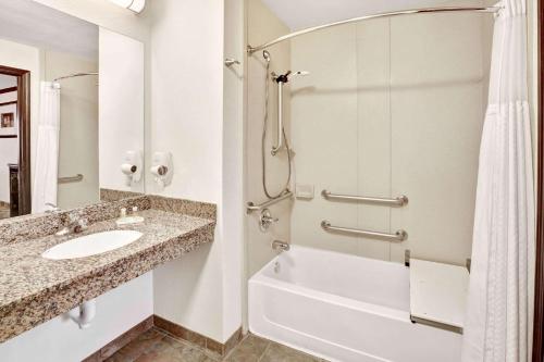 a bathroom with a sink and a shower at Days Inn by Wyndham Oklahoma City/Moore in Oklahoma City